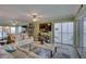 Bright living room with comfortable seating, a large TV, and access to a private balcony with a view at 6310 Midnight Pass Rd # 204N, Sarasota, FL 34242