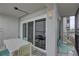 Outdoor patio offers seating with a table and chairs, and a sliding glass door to an indoor seating area at 6310 Midnight Pass Rd # 204N, Sarasota, FL 34242