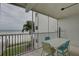 The outdoor patio provides beach views and seating with a table and chairs, with views of a nearby beach at 6310 Midnight Pass Rd # 204N, Sarasota, FL 34242
