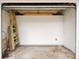 Spacious two-car garage with ample storage space, featuring a ladder and broom at 673 Folsom S St, St Petersburg, FL 33707