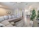 Living room featuring a large sofa, light wood floors, and an open view to the kitchen at 6785 47Th N Ln, Pinellas Park, FL 33781