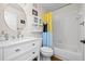 Clean bathroom featuring a vanity with quartz countertops, tile shower, and a decorative mirror at 701 Mirror Lake N Dr # 216, St Petersburg, FL 33701