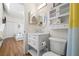 Bright bathroom featuring a white vanity with marble countertop and a matching storage cabinet above the toilet at 701 Mirror Lake N Dr # 216, St Petersburg, FL 33701