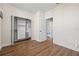 Bright bedroom featuring wood-look flooring, a mirrored closet and ensuite bathroom at 701 Mirror Lake N Dr # 216, St Petersburg, FL 33701