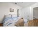 Relaxing bedroom features a queen bed with a stylish fish print bedding set and closet with drawers at 701 Mirror Lake N Dr # 216, St Petersburg, FL 33701