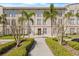 Beautiful condo building featuring manicured landscaping and palm trees in the front of the building at 701 Mirror Lake N Dr # 216, St Petersburg, FL 33701