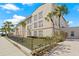 The exterior of the building with manicured lawns, palm trees, and decorative brick accents at 701 Mirror Lake N Dr # 216, St Petersburg, FL 33701