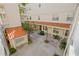 Aerial shot of a courtyard offering a beautiful view of plants and a red tile roof at 701 Mirror Lake N Dr # 216, St Petersburg, FL 33701