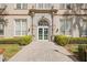 The historic building has an impressive arched doorway with manicured landscaping at 701 Mirror Lake N Dr # 216, St Petersburg, FL 33701