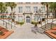 Beautiful entrance to building with large arched windows, manicured plants, and steps leading to door at 701 Mirror Lake N Dr # 216, St Petersburg, FL 33701