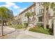 Exterior shot of a multi-story building featuring lush landscaping and mature palm trees at 701 Mirror Lake N Dr # 216, St Petersburg, FL 33701