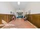An inviting hallway with wood paneling, terracotta tile, and hanging pendant lights at 701 Mirror Lake N Dr # 216, St Petersburg, FL 33701