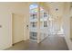 Hallway view featuring an elevator and walkway with white railings and bright natural light at 701 Mirror Lake N Dr # 216, St Petersburg, FL 33701