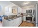 A kitchen featuring white cabinets and stainless steel appliances at 701 Mirror Lake N Dr # 216, St Petersburg, FL 33701