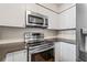 A kitchen featuring white cabinets, stainless steel appliances and granite countertops at 701 Mirror Lake N Dr # 216, St Petersburg, FL 33701