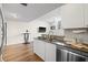 Modern kitchen with stainless steel appliances, breakfast bar, and open view to living area at 701 Mirror Lake N Dr # 216, St Petersburg, FL 33701