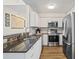 A kitchen featuring white cabinets, stainless steel appliances and a breakfast bar at 701 Mirror Lake N Dr # 216, St Petersburg, FL 33701