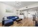 Open-concept living space with modern furniture, wood floors, and a view into the kitchen at 701 Mirror Lake N Dr # 216, St Petersburg, FL 33701
