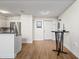 Cozy living area with wood floors, a dining table, and easy access to the kitchen at 701 Mirror Lake N Dr # 216, St Petersburg, FL 33701