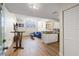 Open-concept living room with wood floors, comfortable seating, and modern kitchen area at 701 Mirror Lake N Dr # 216, St Petersburg, FL 33701