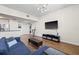Spacious living room with a large TV, modern entertainment center, and a comfortable sectional sofa at 701 Mirror Lake N Dr # 216, St Petersburg, FL 33701