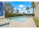 Relaxing outdoor pool area with lounge chairs, an umbrella, and views of the city skyline at 701 Mirror Lake N Dr # 216, St Petersburg, FL 33701