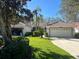 Charming single story home featuring a well manicured front lawn, two car garage, and red tiled roof at 7129 Melrose Pl, Bradenton, FL 34203