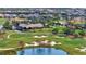 Aerial view of community clubhouse, golf course, and surrounding homes at 7233 Whittlebury Trl, Bradenton, FL 34202