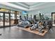 Gym with modern treadmills and elliptical machines, with an exterior view through the windows at 7233 Whittlebury Trl, Bradenton, FL 34202