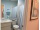 Bathroom features a shower/tub combo with blue and white striped shower curtain, toilet, and vanity at 8055 Picketts Ct # 1, Weeki Wachee, FL 34613