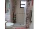 Bathroom features a shower with two shower heads, shower curtain, pink rug, and tiled floor at 8055 Picketts Ct # 1, Weeki Wachee, FL 34613