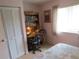 Bedroom featuring desk and storage space with a white closet with louvered doors at 8055 Picketts Ct # 1, Weeki Wachee, FL 34613