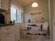 Bright breakfast nook features a white wicker dining set, a white sideboard and backyard view at 8055 Picketts Ct # 1, Weeki Wachee, FL 34613