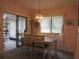 Cozy dining room with a glass sliding door to an outdoor patio and a classic chandelier at 8055 Picketts Ct # 1, Weeki Wachee, FL 34613