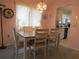 Charming dining room with a wooden table, four chairs, and a chandelier lighting in front of the kitchen at 8055 Picketts Ct # 1, Weeki Wachee, FL 34613