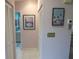 Hallway featuring light pink walls, tiled flooring, and various pieces of art at 8055 Picketts Ct # 1, Weeki Wachee, FL 34613