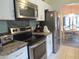 Kitchen showcasing stainless steel appliances, granite countertops, and an adjacent dining area at 8055 Picketts Ct # 1, Weeki Wachee, FL 34613