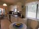Well-lit kitchen with white cabinets, stainless steel appliances, and an adjacent breakfast area at 8055 Picketts Ct # 1, Weeki Wachee, FL 34613