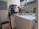 Bright laundry room featuring a modern washer and dryer, storage shelving, and room for organizing cleaning supplies at 8055 Picketts Ct # 1, Weeki Wachee, FL 34613