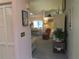 Cozy living room entrance with a closet, an open dining area, and a comfortable seating arrangement with lamps at 8055 Picketts Ct # 1, Weeki Wachee, FL 34613