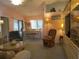 Inviting living room and dining area featuring a warm color scheme and comfortable seating arrangements with a light fixture at 8055 Picketts Ct # 1, Weeki Wachee, FL 34613