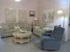 Comfortable living room area with dual sofas, a decorative table, a lamp and art displays on pink walls at 8055 Picketts Ct # 1, Weeki Wachee, FL 34613