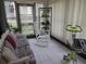 Sun room with tile floors, natural light, comfortable futon and rocking chair, perfect for relaxation and enjoying the view at 8055 Picketts Ct # 1, Weeki Wachee, FL 34613