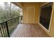 This balcony features a wooden floor, black metal railing, and a nice view at 8659 Fancy Finch Dr # 202, Tampa, FL 33614
