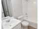 Bathroom with white tiled shower/tub, modern vanity, and neutral paint at 8659 Fancy Finch Dr # 202, Tampa, FL 33614