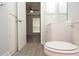 Bathroom featuring a white vanity, medicine cabinet, and toilet with modern fixtures and wood-look flooring at 8659 Fancy Finch Dr # 202, Tampa, FL 33614