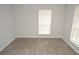Well-lit bedroom with large windows and updated flooring, offering a relaxing retreat at 8659 Fancy Finch Dr # 202, Tampa, FL 33614