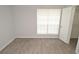 Bright bedroom with a window, wood-look flooring and closet at 8659 Fancy Finch Dr # 202, Tampa, FL 33614