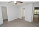 This bedroom features neutral walls, gray flooring, and a ceiling fan at 8659 Fancy Finch Dr # 202, Tampa, FL 33614
