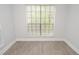 Bright bedroom showcasing large window and modern flooring, perfect for a relaxing retreat at 8659 Fancy Finch Dr # 202, Tampa, FL 33614